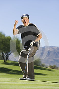 Man gesturing on golf course