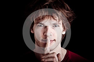 Man gesturing for quiet