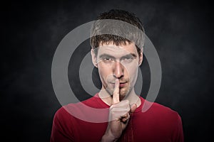 Man gesturing silence.