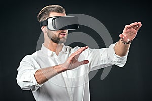 man gesturing and using virtual reality headset,