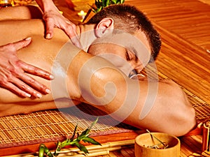 Man getting bamboo massage