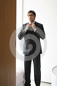Man getting dressed in hir bedroom