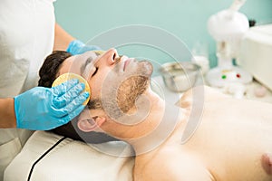 Man getting a facial cleanse