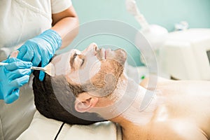 Man getting a facial treatment