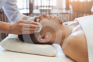 Man getting facial treatment at beauty salon