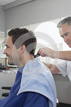 Man Getting An Haircut From Hairdresser