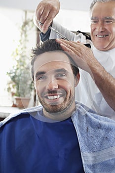 Man Getting An Haircut From Hairdresser