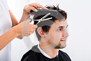 Man Getting Haircut From Hairdresser