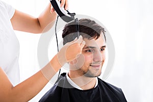 Man Getting His Haircut From Hairdresser