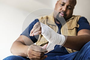 A man getting injured putting on bandages photo