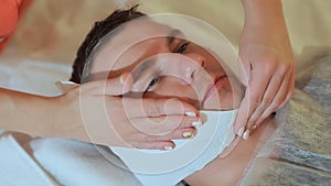 Man getting massage in the spa centre. Drying facial wipes. Massage the face and neck.