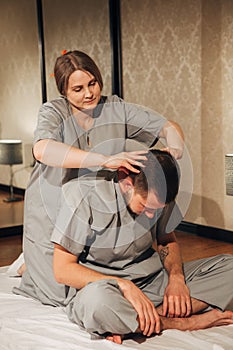 Man getting massage in spa. Female therapist