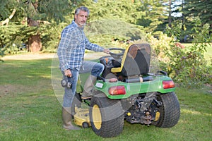 Man getting on ride on mower