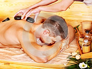 Man getting stone therapy massage .