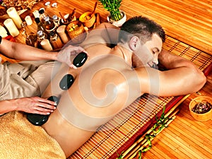 Man getting stone therapy massage .