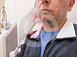 Man getting UV heat treatment at clinic photo