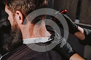 Man getting trendy haircut in barber shop