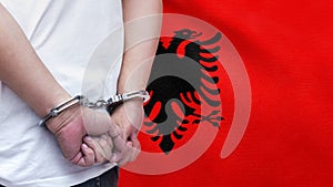 A man getting under arrest in Albania. Concept of being handcuffed, detained, incarcerated and jailed in said country. National