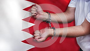 A man getting under arrest in Bahrain. Concept of being handcuffed, detained, incarcerated and jailed in said country. National