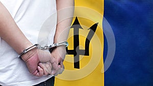 A man getting under arrest in Barbados. Concept of being handcuffed, detained, incarcerated and jailed in said country. National
