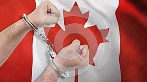 A man getting under arrest in Canada. Concept of being handcuffed, detained, incarcerated and jailed in said country. National law
