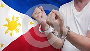 A man getting under arrest in the Philippines. Concept of being handcuffed, detained, incarcerated and jailed in said country.