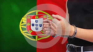 A man getting under arrest in Portugal. Concept of being handcuffed, detained, incarcerated and jailed in said country. National