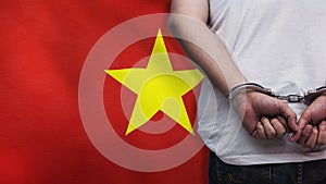 A man getting under arrest in Vietnam. Concept of being handcuffed, detained, incarcerated and jailed in said country. National