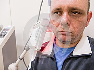 Man getting UV heat treatment at clinic photo