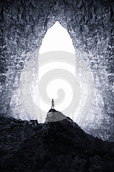 Man at giant cave portal