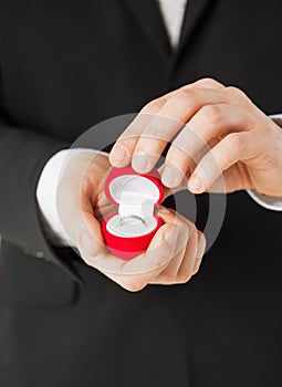 Man with gift box and wedding ring