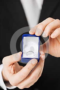 Man with gift box and wedding ring