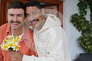 Man gifting flowers to his handsome boyfriend