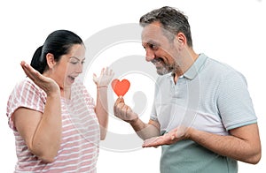 Man gifting paper heart to woman