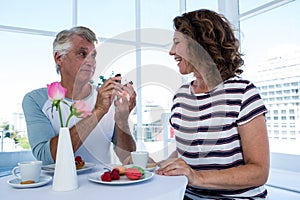 Man gifting ring to woman