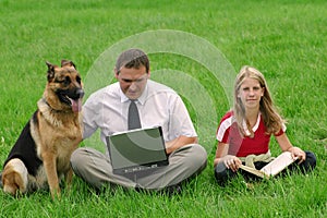 Man, girl and dog sitting