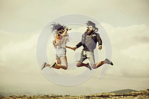 Man and girl jump high