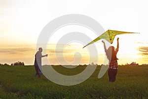 A man with a girl launches a kite