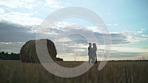 Man and girl in love romantic lovers kissed, hugged sunset, sunrise against background of mountains and mist, sun