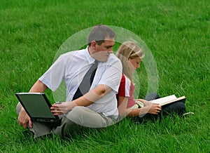 Man and girl sitting in the grass