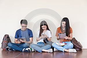 Man and girls friend classmates sitting useing technology