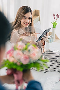 Man give flower bunch to woman