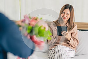 Man give flower bunch to woman