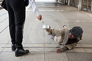 Man give money to disabled homeless man