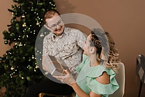 A man gives a gift to a woman for the new year.