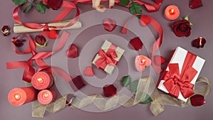 Man gives present to woman. Present gift box wrapped with red ribbon and craft paper. Valentine`s Day gifts on festive table backg