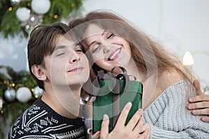 A man gives a woman a Christmas present