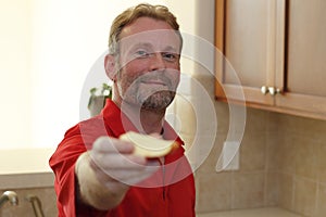 Man Giving Apple Slice to Viewer