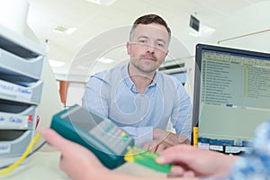 man giving card to doctor