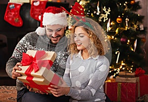 Man giving a Christmas present to his girlfriend